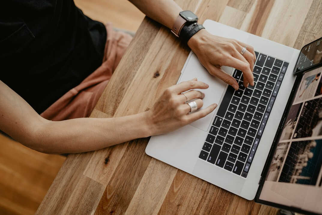 person sending email on laptop