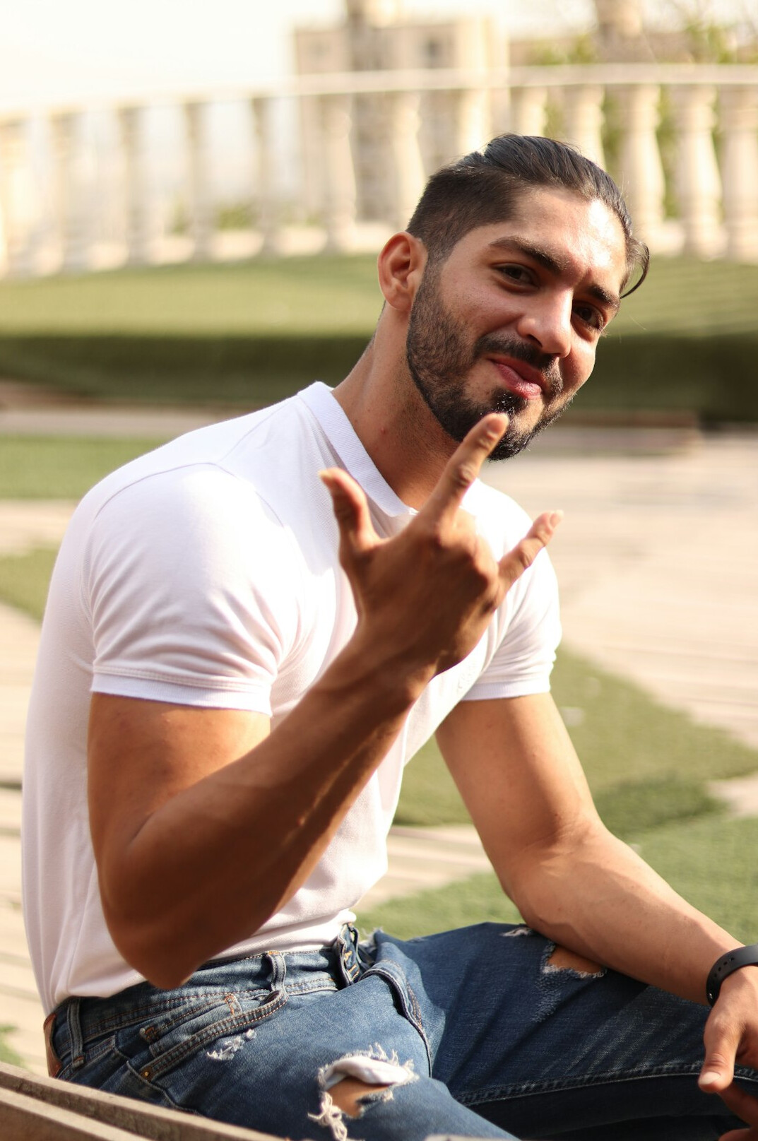 Smiling young man with short dark hair and beard